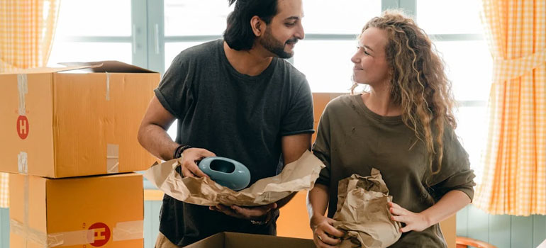 How to Downsize Your Belongings Before Moving to Cincinnati 6 a couple packing talking about how to downsize your belongings for a move