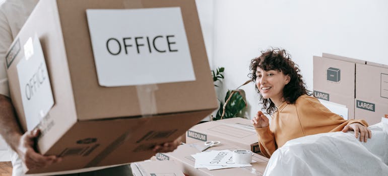 How to Downsize Your Belongings Before Moving to Cincinnati 2 a woman in a room with boxes