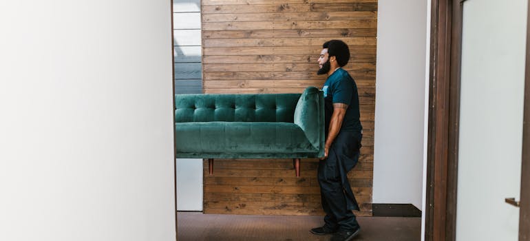 How to Downsize Your Belongings Before Moving to Cincinnati 4 a mover with a couch