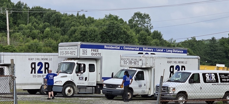 Why are companies moving to Ohio? 3 Ready 2 Roll moving trucks in a parking lot in front of a business complex