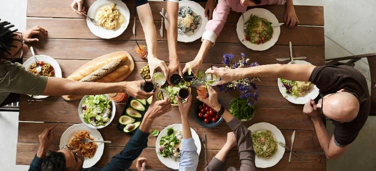 How greater Cincinnati celebrates Thanksgiving: Traditions, events, and local favorites 6 Friends raising glasses during a shared meal