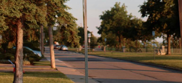 Actionable relocation guide to Hamilton Ohio 1 Quiet Hamilton residential street with trees and parked cars