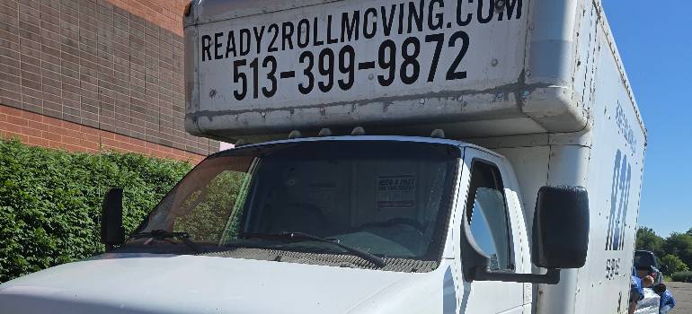 A comprehensive guide for families moving to Hamilton OH 8 Ready2Roll moving truck parked beside brick building
