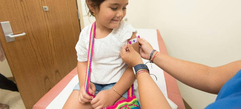 A comprehensive guide for families moving to Hamilton OH 5 Nurse placing colorful bandage on smiling child