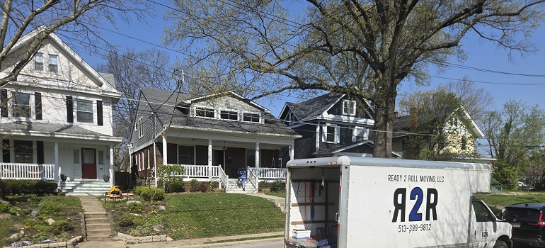Benefits of living in Cincinnati suburbs 1 Moving truck parked outside classic Cincinnati suburban homes