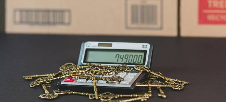 Benefits of living in Cincinnati suburbs 2 House keys on calculator, planning Cincinnati suburb budget