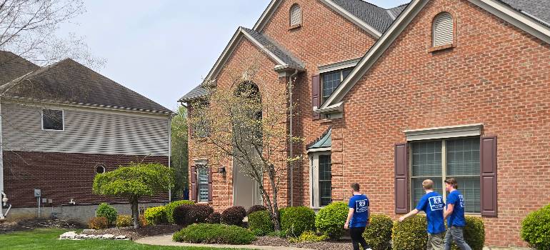 Top reasons families are choosing to relocate to Morrow Ohio 2 Crew approaches large brick house for move-in