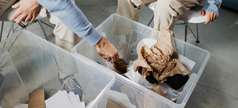 How to dispose of leftover packing materials after moving to Cincinnati? 3 People sorting leftover packing materials after moving to Cincinnati