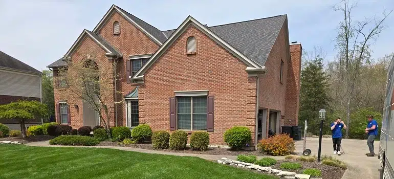 Why are families moving to West Chester Ohio? 5 Spacious brick house with movers preparing front yard