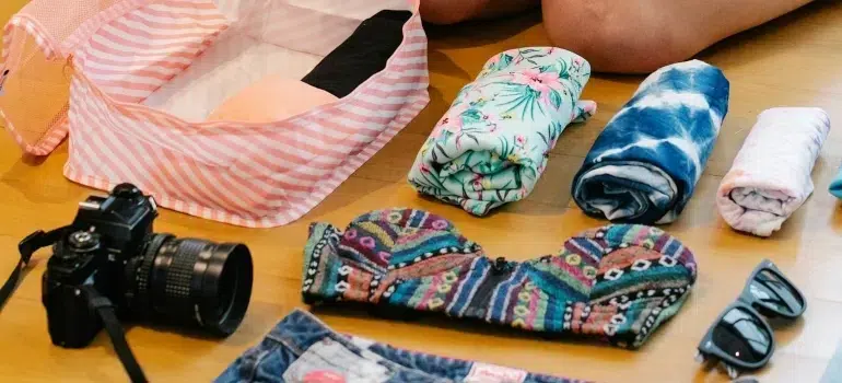 How to pack clothes for moving like a pro 3 Woman using the best way to pack clothes for moving and save space
