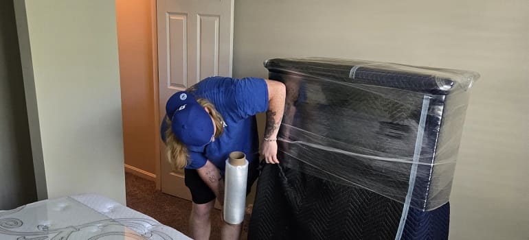 What packing materials are worth buying, and what can you skip? 1 Movers wrapping sofa
